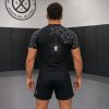 Back view of black BJJ rash guard with spider web shoulder print and hanging spider graphic by Reedot Sports